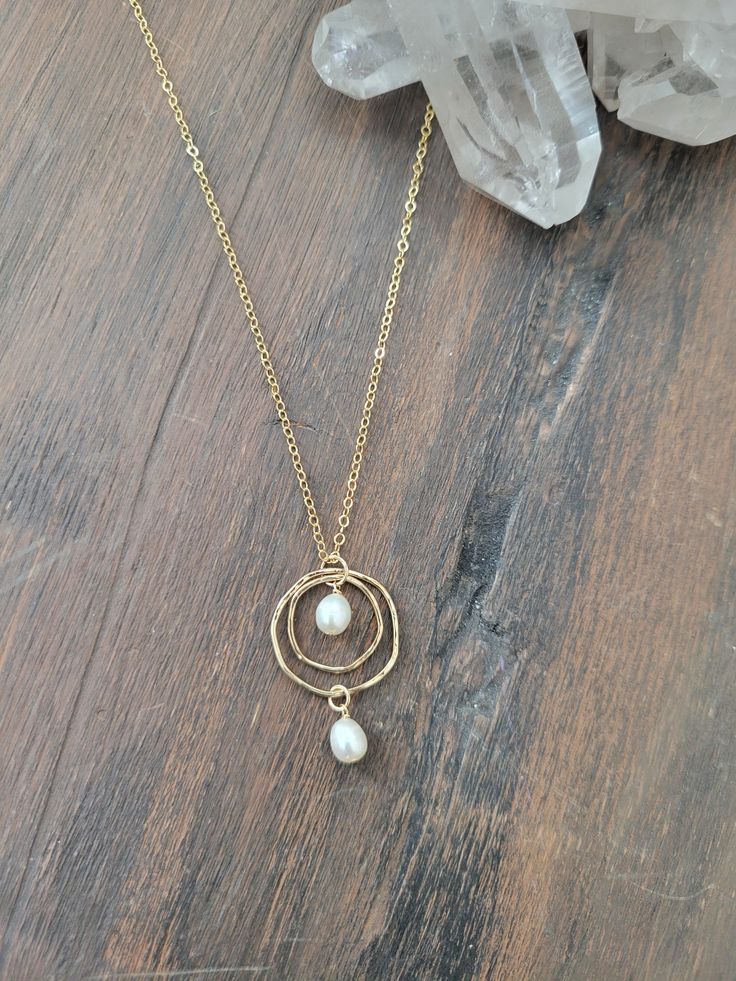 Double Circle Pearl Necklace. A classic beauty that can be worn for years! Dress it up or down, it can be worn with everything and anything! The Circles are organically shaped and hammered for texture and shape. 2 Fresh Water Pearls are attached to the circles. The length of the pendant is about 1 1/4 in. In the pictures, the length is at 18 in. Each piece is handmade and may vary slightly as well as the pearls as they are natural. Thank you! Fresh Water Pearls, Handmade Wire Jewelry, Water Pearls, Chain Necklaces, Handmade Wire, Circle Necklace, Classic Beauty, Earring Necklace, Wire Jewelry