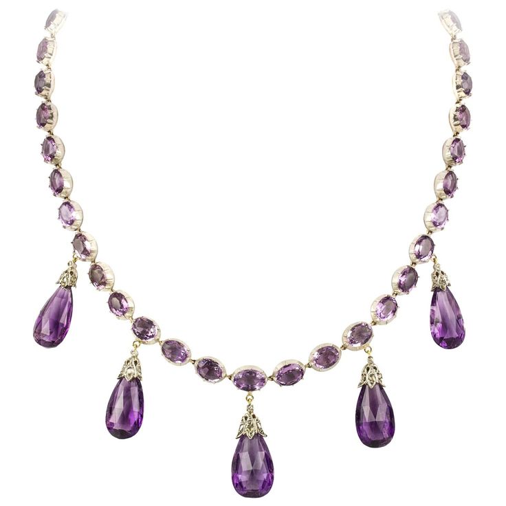 A late Victorian amethyst necklace and earrings, the necklace consisting of thirty-nine oval faceted amethyst, all set in cut-down collets, suspending five pear-shaped briolette-cut amethyst drops each with diamond-set cap of foliate design, all mounted in silver to yellow gold back, accompanied by matching drop earrings with gold wire fittings, circa 1880, the necklace measuring approximately 42 x 3.8cm, the earrings measuring approximately 3.7 x 1.3cm, gross weight 54 grams. Unmarked tested as Purple Stone Necklace, Princess Jewelry, Beaded Bracelets Tutorial, Earrings For Sale, Amethyst Gold, Purple Necklace, Amethyst Jewelry, Fabulous Jewelry, Victorian Jewelry