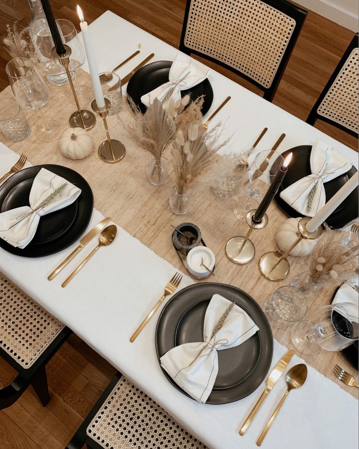 the table is set with black and white place settings