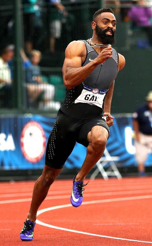 a man with a beard running on a track