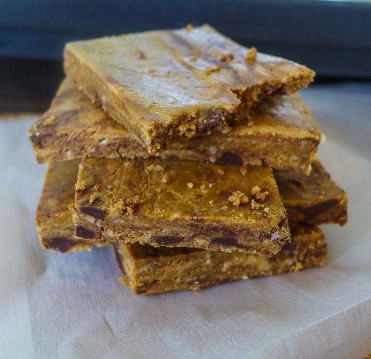 several pieces of chocolate and peanut butter bars stacked on top of each other, ready to be eaten