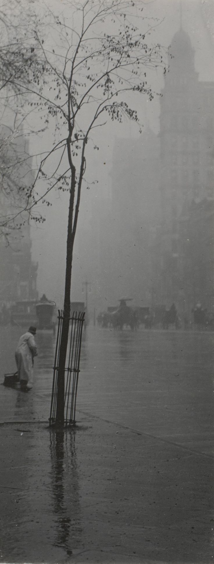 black and white photo of people walking in the rain