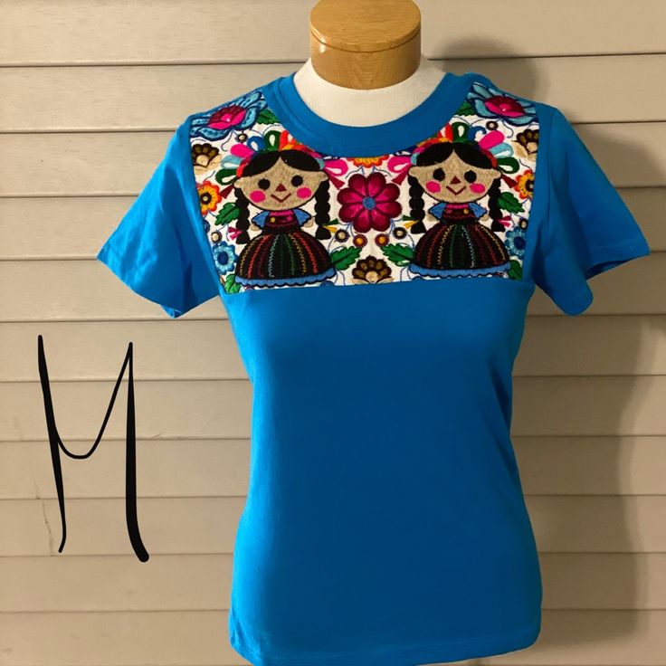 Embroidered Mexican T-Shirt Casual Blue Top With Embroidered Text, Blue Crew Neck T-shirt With Embroidered Text, Casual Blue Tops With Embroidered Graphics, Blue Graphic Tee With Embroidered Text, Blue Embroidered Crew Neck Top, Casual Blue Top With Embroidered Graphics, Blue T-shirt With Embroidered Text For Spring, Blue Tops With Embroidered Text For Spring, Blue Crew Neck T-shirt With Embroidered Graphics