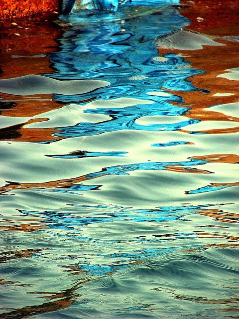 the reflection of trees in the water is very colorful and interesting to see on this photo