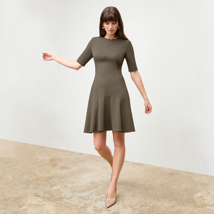 The sleeved cousin of the Jayde dress , the Gina features upper arm coverage, a subtly flouncy, flared skirt, and a just-above-the-knee hemline. Other design details include a classic crew neck and a drop-waist seam. Made in China with fabric from Italy. Flattering Fitted A-line Dresses, Formal Stretch Dress With Flared Skirt, Formal Stretch Flared Skirt Dress, Stretch A-line Dresses With Ruffles, A-line Midi Dress With Fitted Waist, Fit And Flare A-line Midi Dress With Ruffles, Spring Elegant Midi Dress With Flared Hem, Elegant Flared Hem Midi Dress For Spring, Elegant Spring Midi Dress With Flared Hem