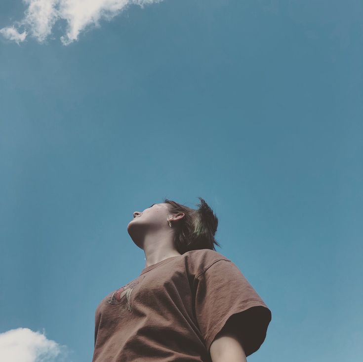 a woman is looking up at the sky