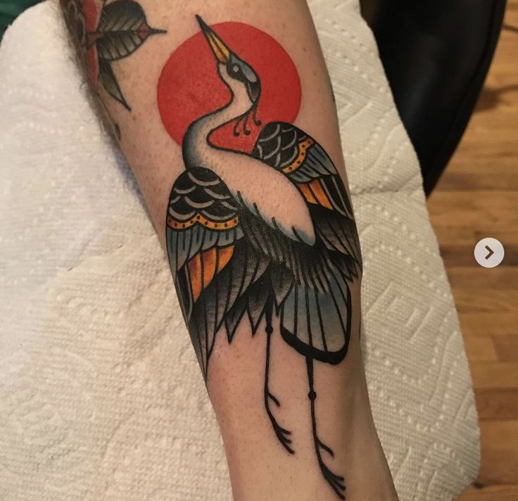 a close up of a person's arm with a bird on it