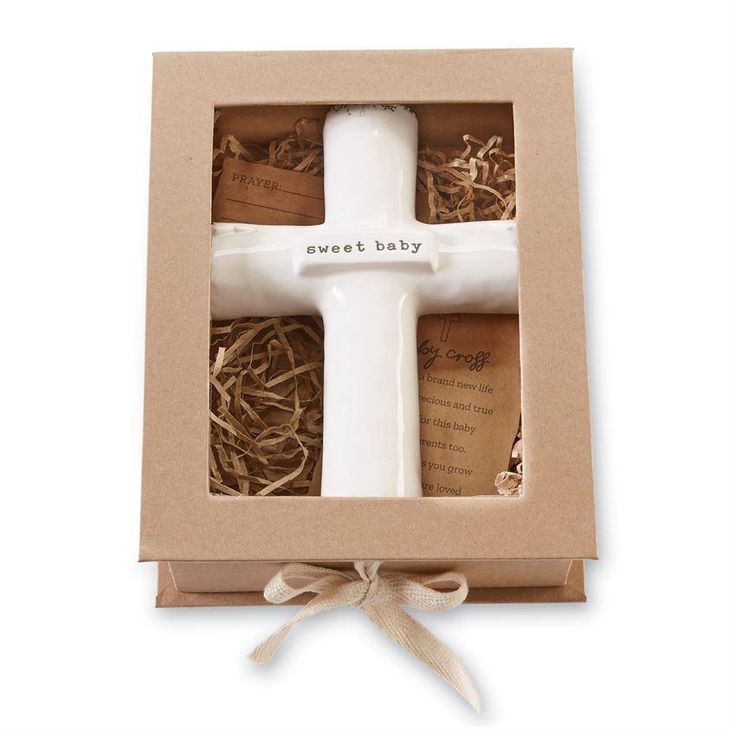 a white cross in a cardboard box with the words sweet baby written on it