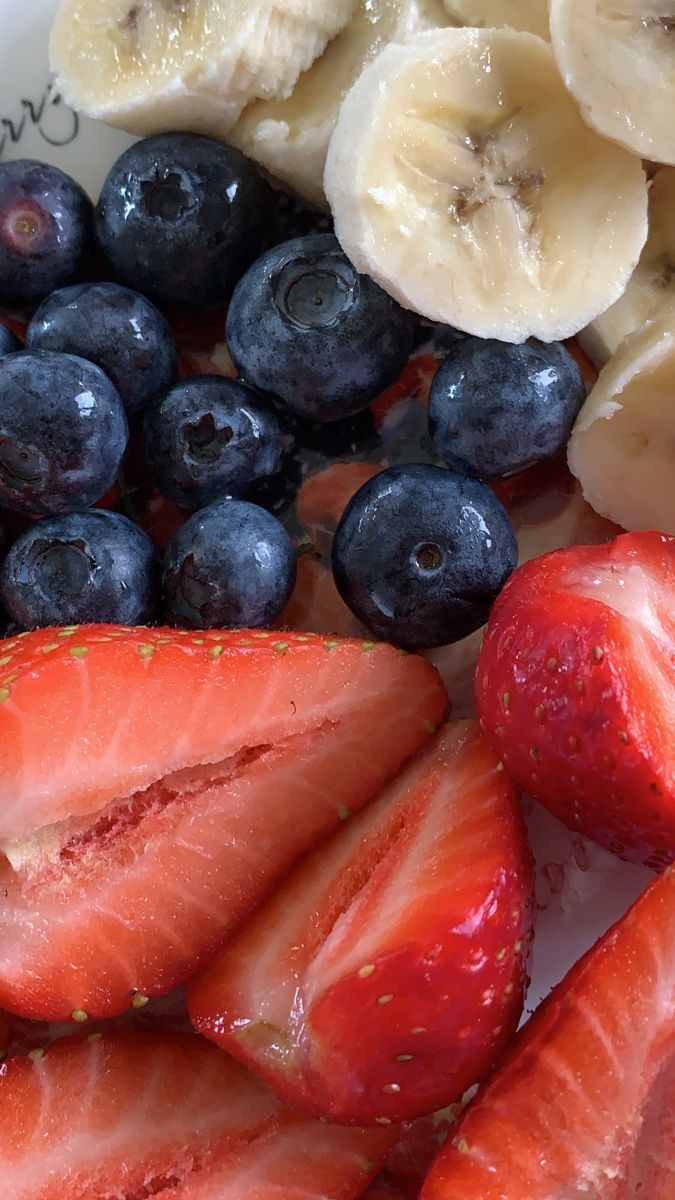 strawberries, bananas and blueberries on a plate