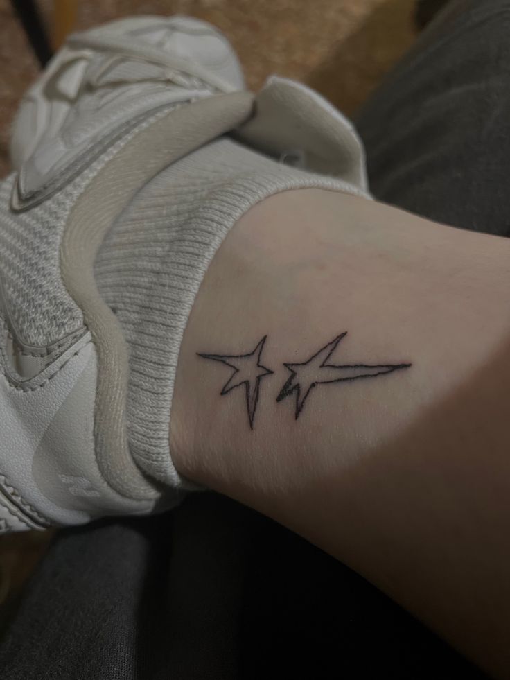 a person with a small star tattoo on their arm