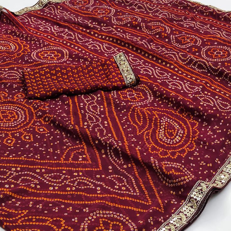 Wine colored saree is made from chiffon fabric which is highlighted with beautiful Pichwai print with weaving work as shown. comes along unstitched chiffon blouse piece which you can customise as per your design/style. Occasion - You can wear this saree for festivals, functions and ideal for any fashionista. Note:- the actual product may differ slightly in color and design from the one illustrated in the images when compared with computer or mobile screen. Measurements: Saree : Chiffon : 5.5 Mtrs Blouse : Chiffon : 0.8 Mtr Material: Chiffon Stitch Type: Unstitched Country of Origin: India Care Guide: Dry Clean Festival Georgette Pre-draped Saree With Printed Border, Bandhani Print Pre-draped Saree For Puja, Multicolor Georgette Blouse With Bandhani Print, Multicolor Georgette Blouse Piece For Puja, Multicolor Georgette Pre-draped Saree For Puja, Georgette Dupatta With Printed Border For Festivals, Multicolor Bandhani Print Georgette Saree, Multicolor Chanderi Blouse Piece With Bandhani Print, Multicolor Choli With Printed Border For Festivals