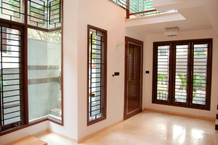 the inside of a house with windows and doors on both sides of the entrance way