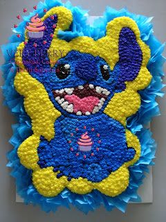 a blue and yellow cake with an animal on it