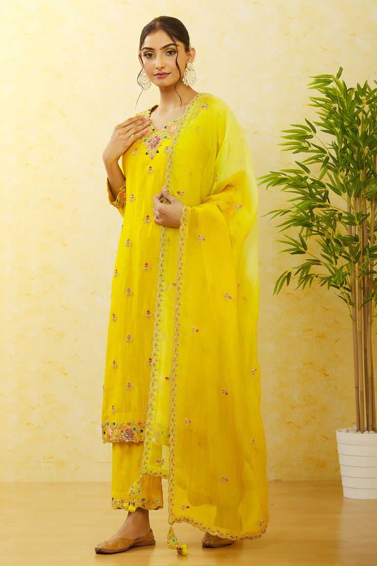 Mustard green pure spun silk kurta with floral, thread and sequins hand embroidery. Comes with pant and a pure organza shaded dupatta.
Components: 3
Pattern: Hand embroidered
Type Of Work: Floral, Thread, Sequins
Neckline: V Neck
Sleeve Type: Three quarter
Fabric: Pure spun silk, Dupatta : Pure organza
Color: Green
Other Details: 
Scalloped detailing on dupatta
Occasion: Mehendi and Haldi,Sangeet - Aza Fashions Tissue Silk Anarkali Set With Dori Work, Festive Tissue Silk Palazzo Set For Diwali, Silk Straight Kurta With Dori Work, Eid Slub Silk Palazzo Set With Sheer Dupatta, Festive Embroidered Tissue Silk Palazzo Set, Yellow Silk Sharara With Dabka Work, Unstitched Slub Silk Suit With Gota Work, Tissue Silk Salwar Kameez For Navratri, Pista Green Silk Palazzo Set For Festivals