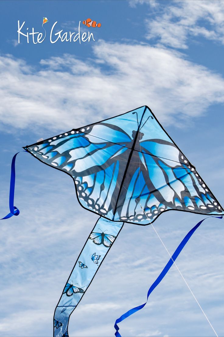 a blue butterfly kite flying in the sky with clouds behind it and text that reads kite garden