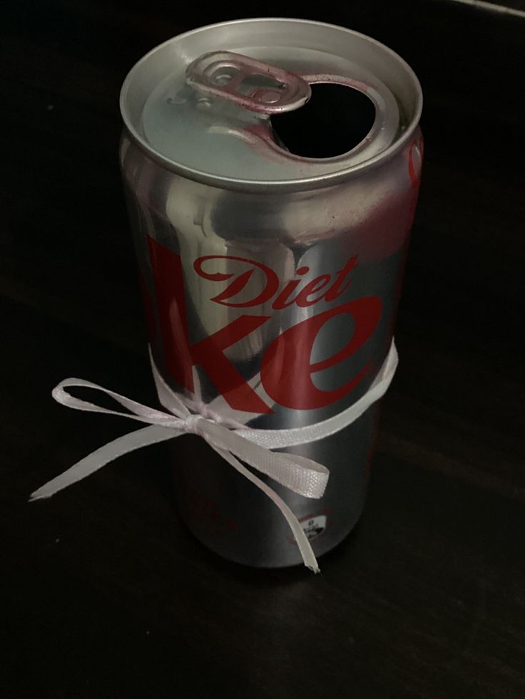 a can of diet coke with a white ribbon tied around it