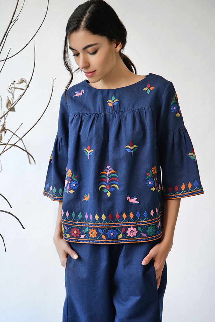 Navy blue top with all over Kutch inspired floral thread work.
Components: 1
Fabric: Cotton linen
Neckline: Wide
Sleeve Length: Three quarters
Color: Blue
Embroidery
Bell sleeves
Closure: Back buttons
Note: Pants worn by the model is not for sale - Aza Fashions Folklore Embroidery, Payal Pratap, Navy Blue Top, Blue Embroidery, Top For Women, Thread Work, Peasant Tops, Blue Top, Off Shoulder Tops