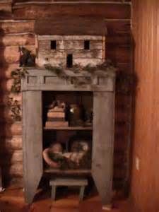 an old fireplace in a log cabin with decorations on the mantle and shelf above it