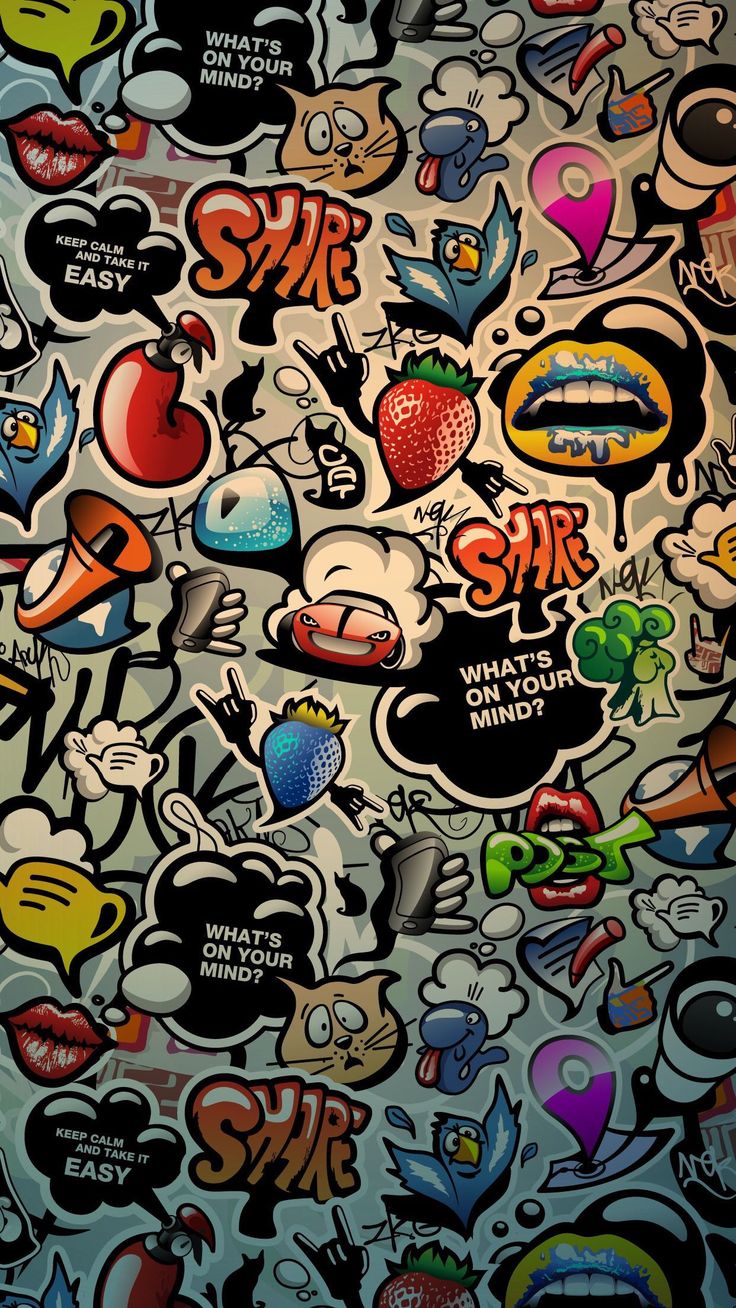 a bunch of stickers on the side of a wall that is covered in graffiti