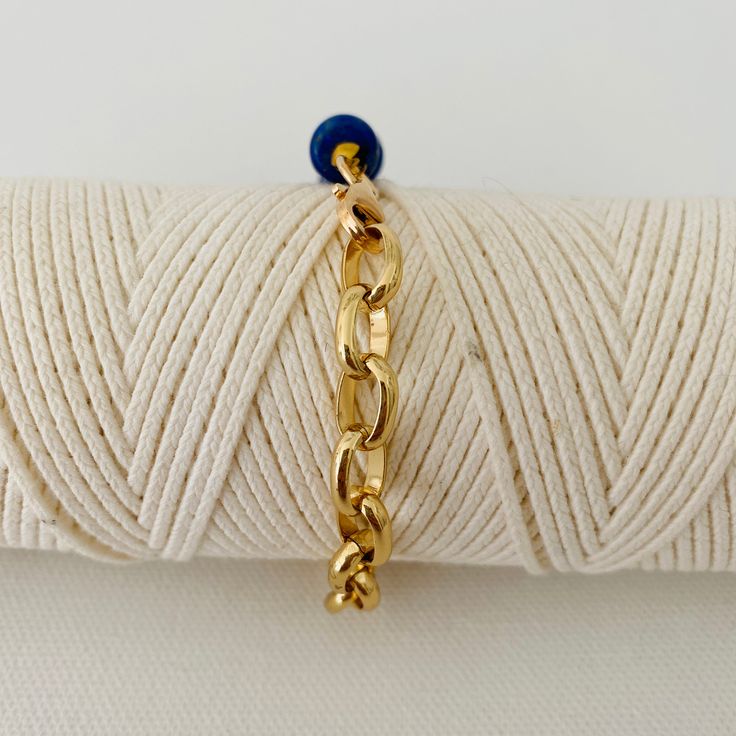 This is two looks in one bracelet. Half of the bracelet is beaded with gold and lapis beads and the other half is a chunky bold gold chain. It measures 18 inches in length and can be adjusted to a smaller size. Please note that the white bracelet shown in some of the photos is not included but can be purchased under Nico-White Gold Metal Chain Bracelet With Beaded Chain, Gold Metal Chain Bracelet With Beaded Detail, Gold Metal Chain Bracelet With Beads, Blue Adjustable Chain Bracelet For Everyday, Everyday Blue Bracelet With Adjustable Chain, Gold Beaded Lapis Lazuli Bracelets, Adjustable Blue Chain Bracelet, White Bracelet, The Other Half