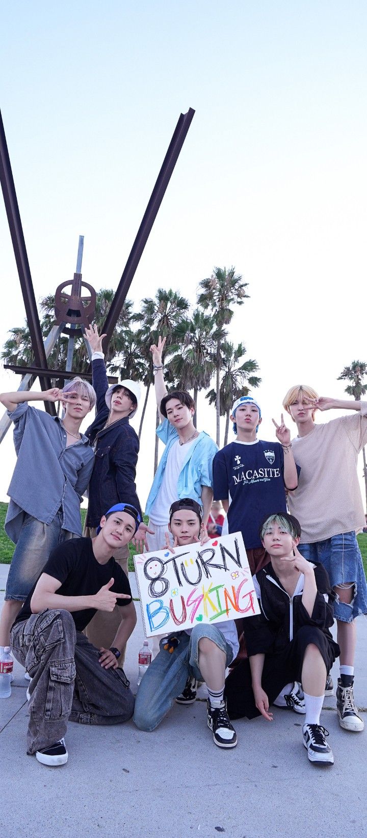 a group of young men standing next to each other holding up a sign that says story surfing