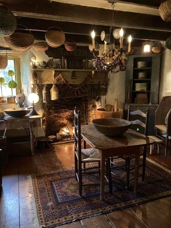 an old fashioned living room with a fireplace and lots of lights hanging from the ceiling