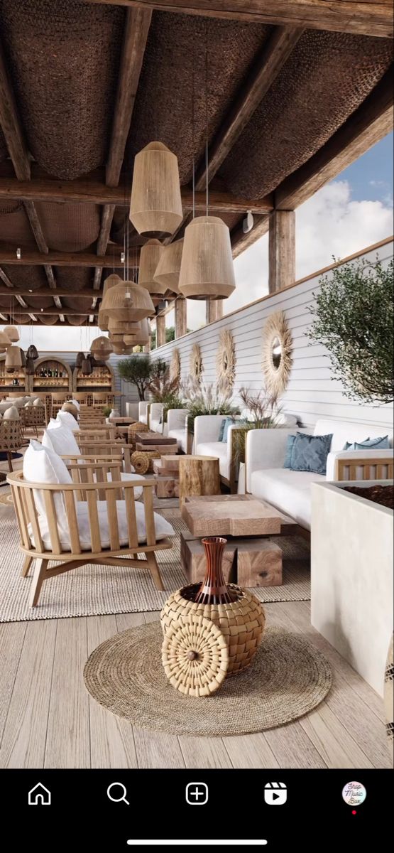 an outdoor living area with wooden furniture and hanging lights on the ceiling, along with potted plants