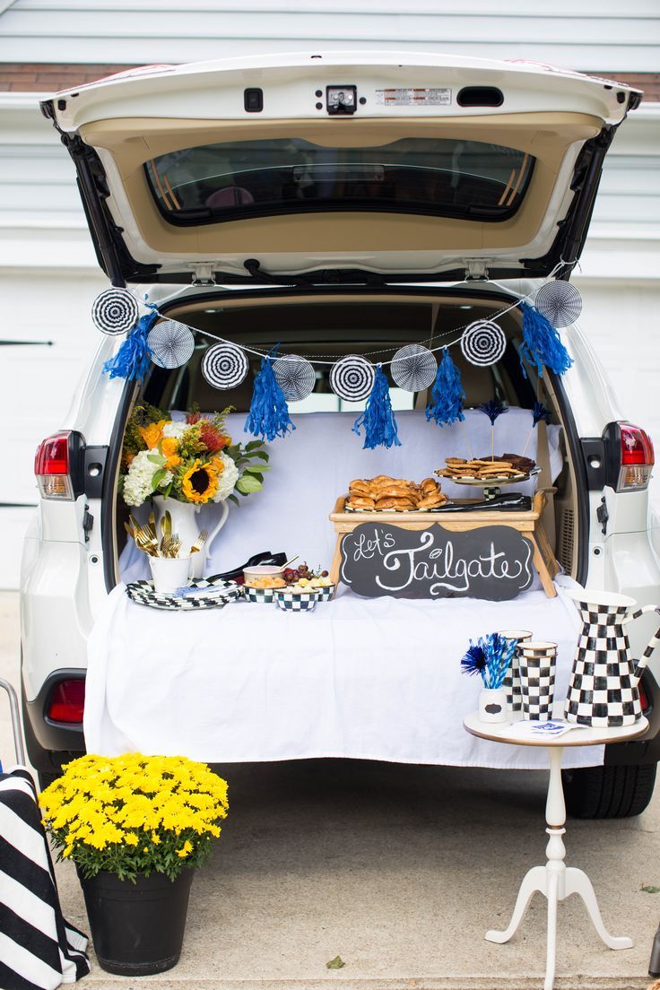 the trunk of a car is filled with food and decorations