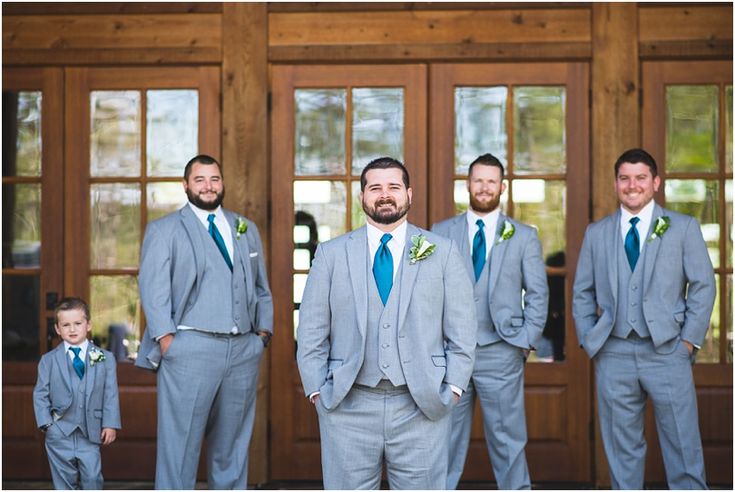 a group of men in suits standing next to each other