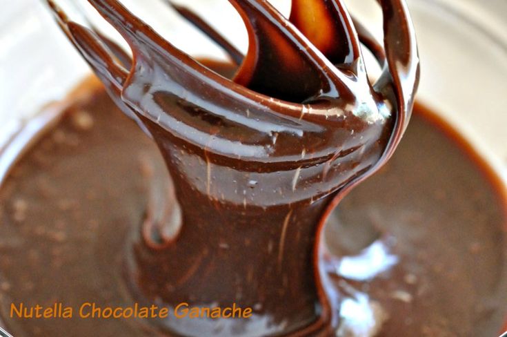 melted chocolate in a glass bowl with a whisk