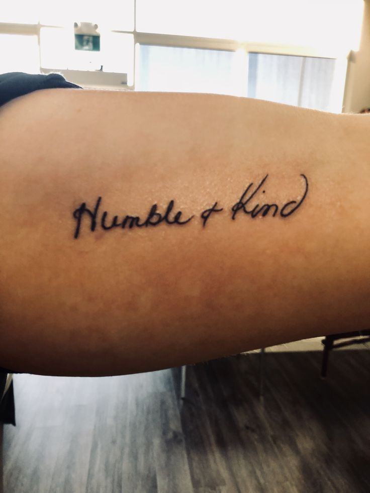 a woman's arm with the words humble and kind written on it in cursive font