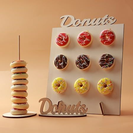 there are donuts on display next to a cupcake and a sign that says donuts