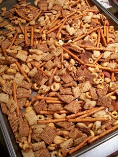 there are many different types of snacks in the trays on this counter top, including crackers and pretzels