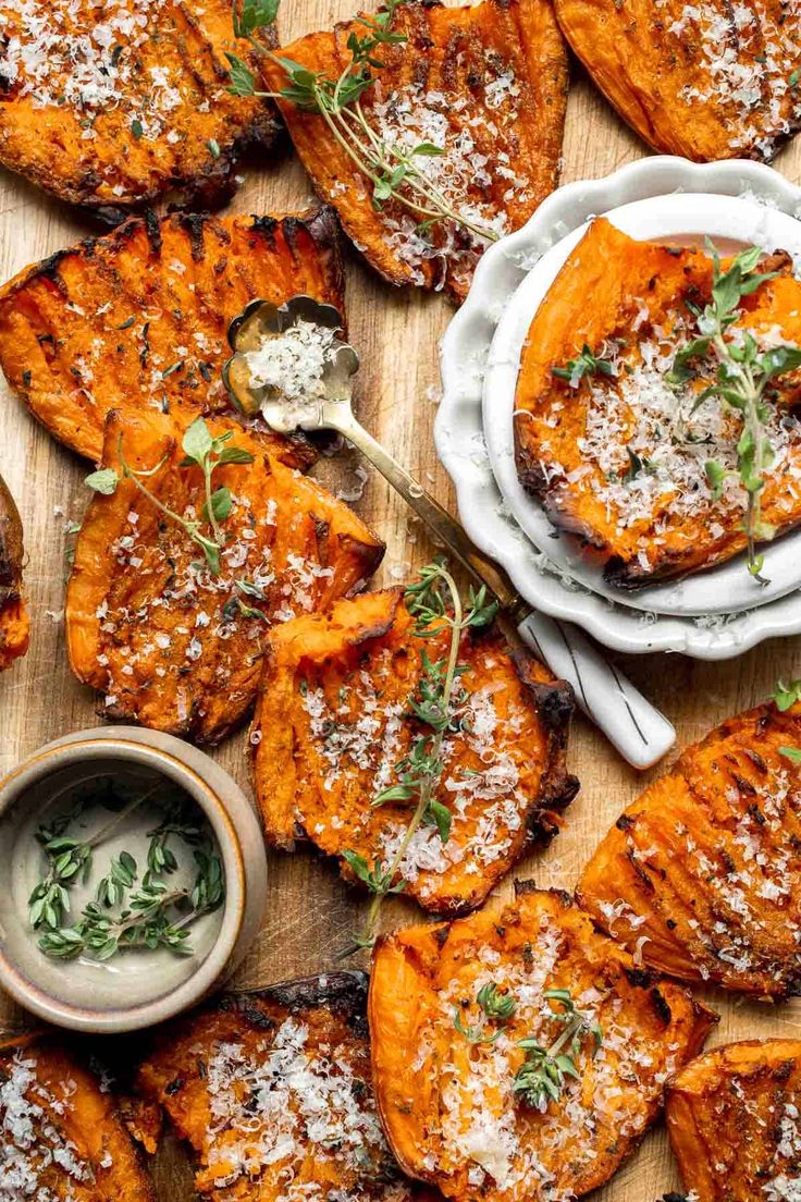 grilled sweet potatoes with parmesan cheese and herbs on the side, served in small dishes