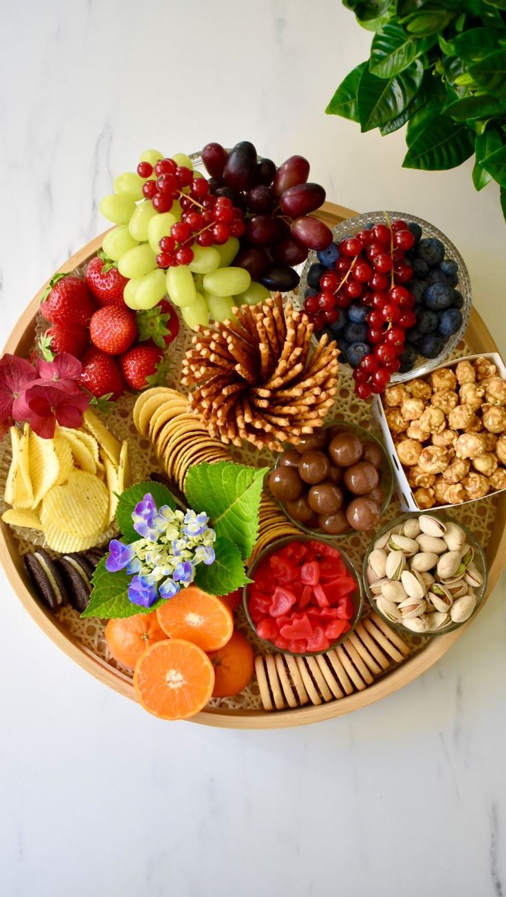 a platter filled with fruit and nuts