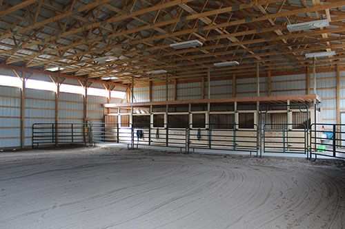 the inside of an empty building with metal bars and fencing on each side of the door