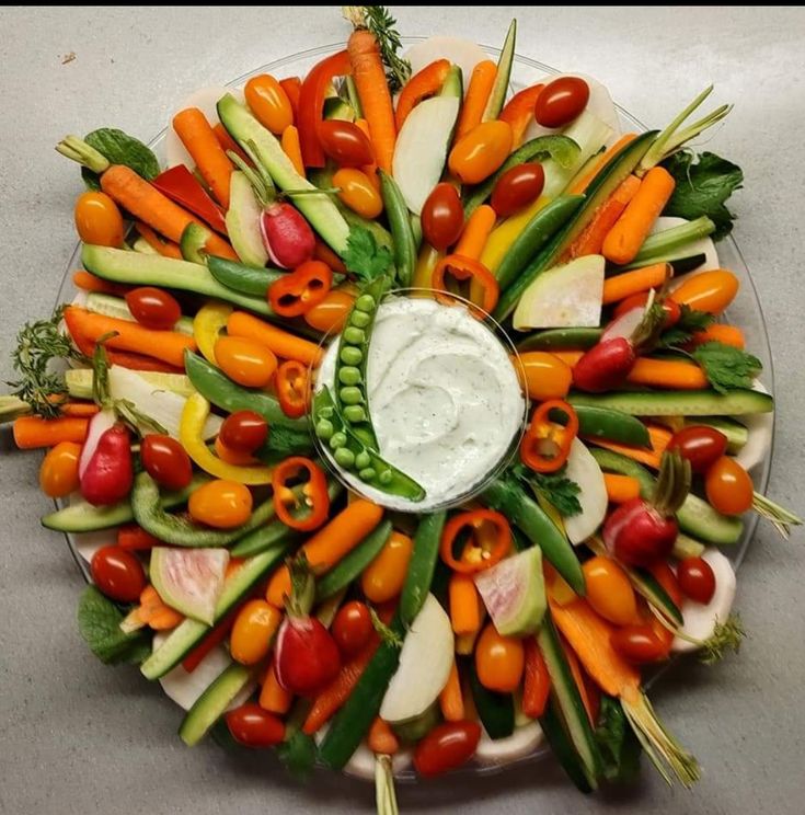 a platter filled with vegetables and dip