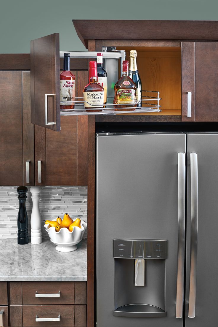 a silver refrigerator freezer sitting in a kitchen next to a counter top with fruit