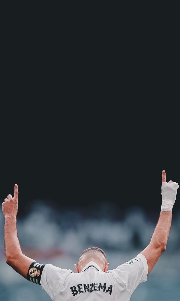 a baseball player holding his hands up in the air