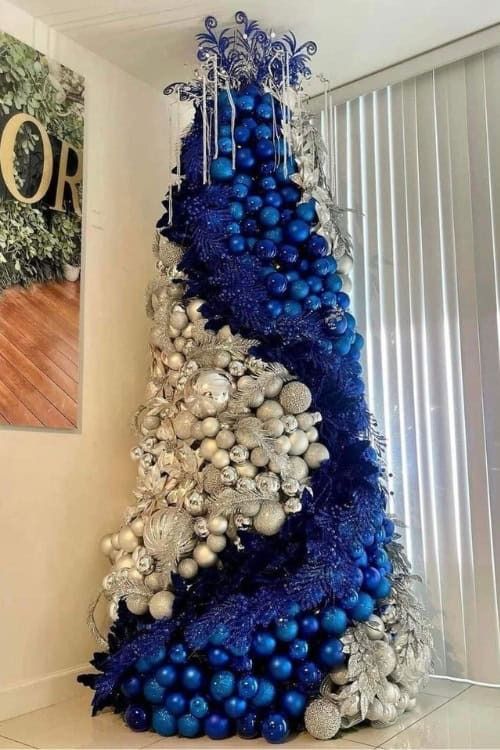 a blue and silver christmas tree with ornaments