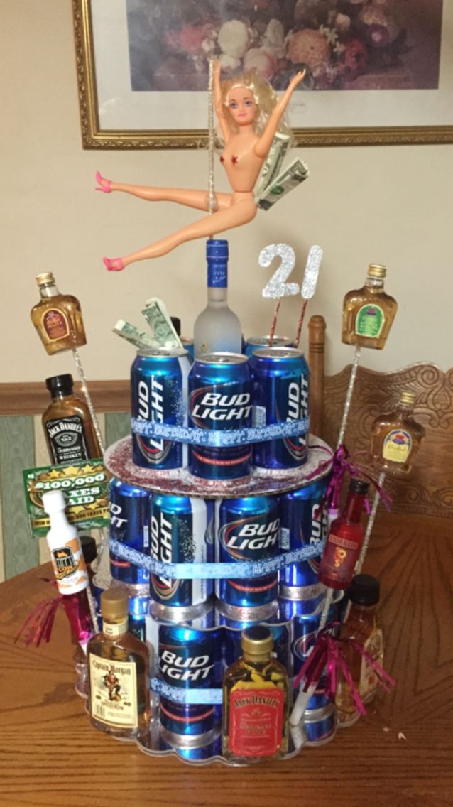 a cake made to look like a stack of soda cans with a woman on top