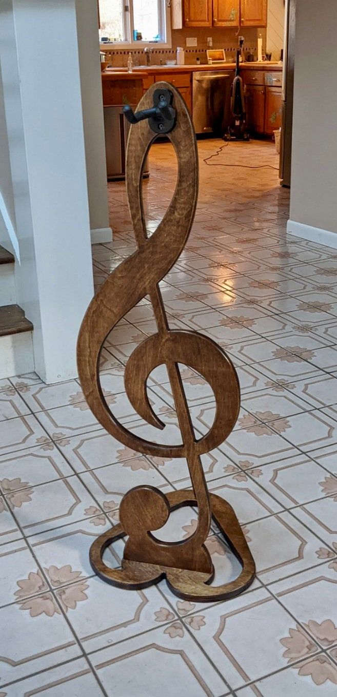 a wooden treble sitting on top of a tiled floor