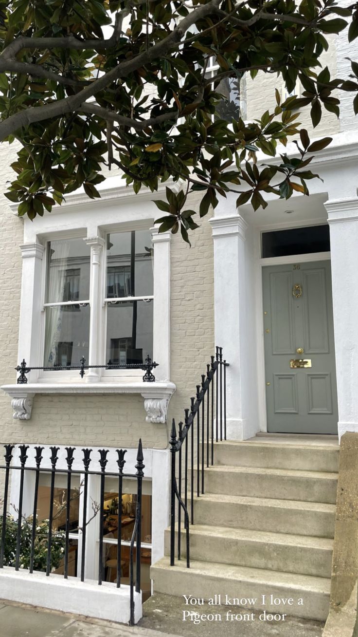 the front door of a house with stairs leading up to it