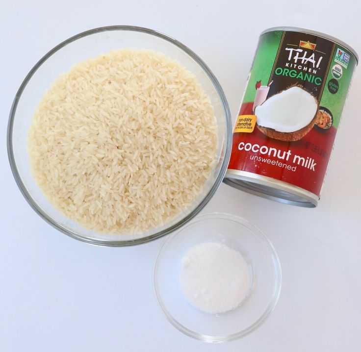 a can of coconut milk next to a bowl of rice