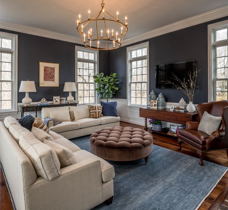 a living room filled with furniture and a chandelier