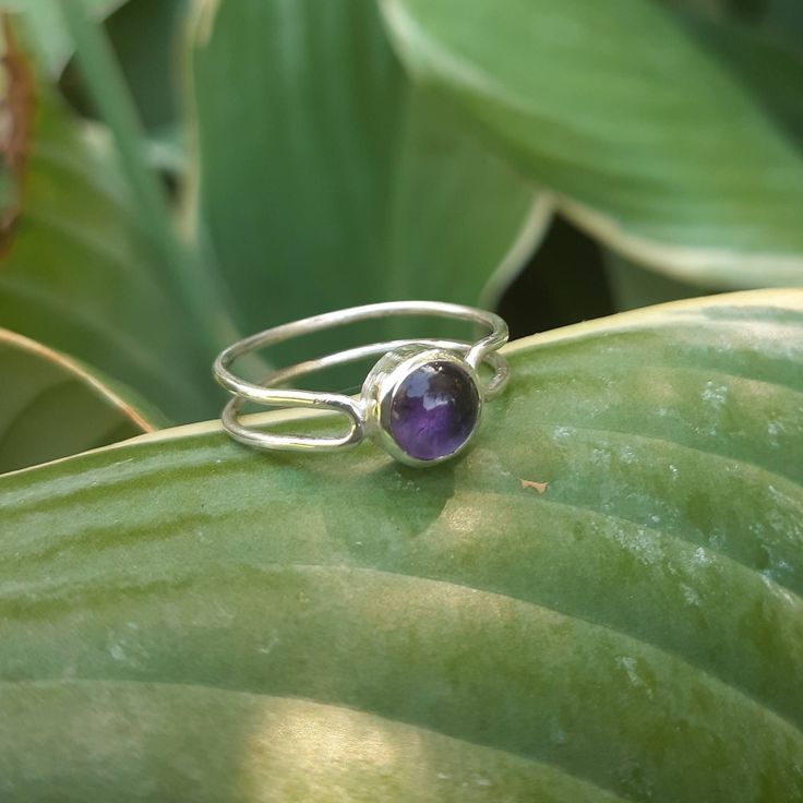 This purple amethyst ring is designed and crafted for everyday wear. This ring is understated yet elegant, and the double-band makes it more of a statement piece. Wear stacked with other rings or on its own. The ring fits as a size 6. Sterling silver may tarnish over time but can be very easily shined with a polishing cloth or silver cleaning solution to keep it looking brand new.  Follow me on Instagram for more @wildcarrotjewelry Minimalist Amethyst Gemstone Ring, Dainty Purple Amethyst Ring, Adjustable Purple Birthstone Ring, Modern Purple Ring, Purple Sterling Silver Birthstone Ring, Minimalist Silver Amethyst Jewelry, Minimalist Silver Amethyst Ring, Sterling Silver Amethyst Ring With Bezel Setting, Purple Sterling Silver Birthstone Ring With Round Stone