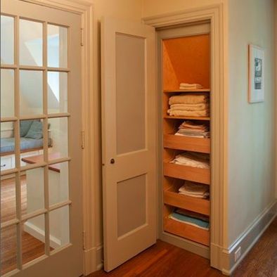 an empty room with wooden floors and white doors