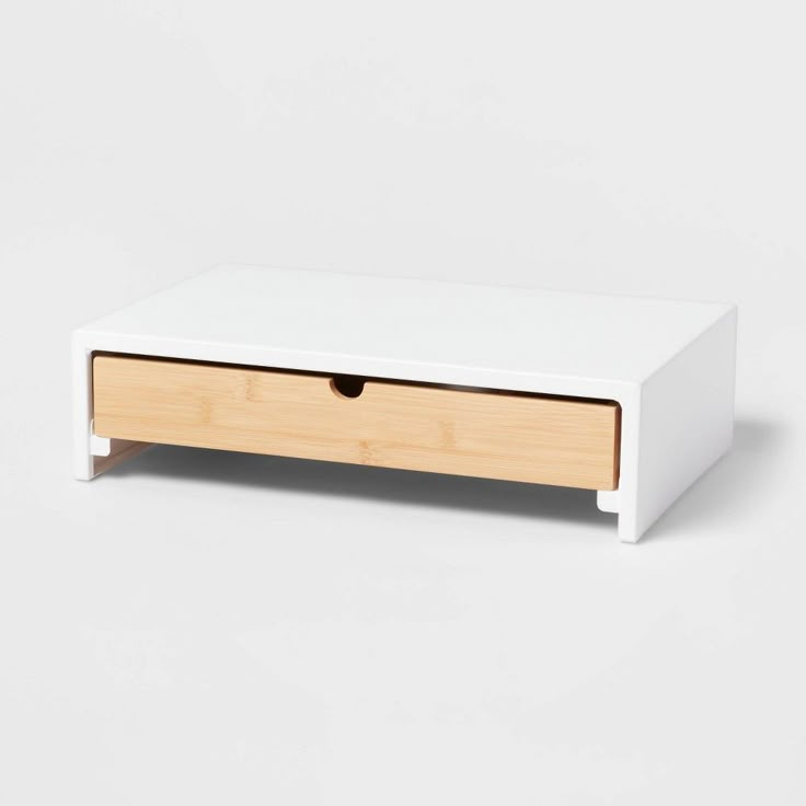 a white wooden drawer with two drawers on each side and an open drawer at the bottom