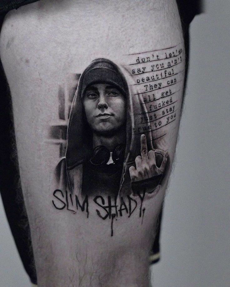 a man's leg with a black and white photo on it that says slim shady