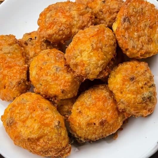 a white plate topped with fried food on top of a table